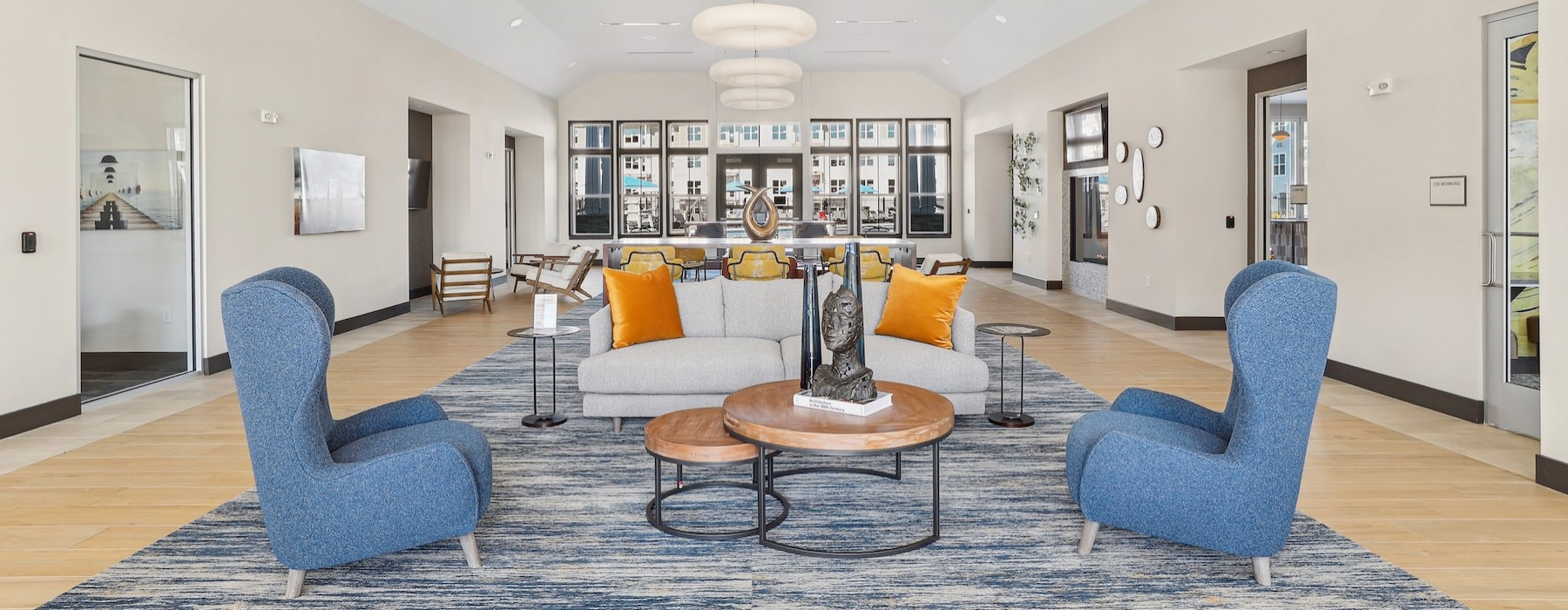 a large living room with blue chairs