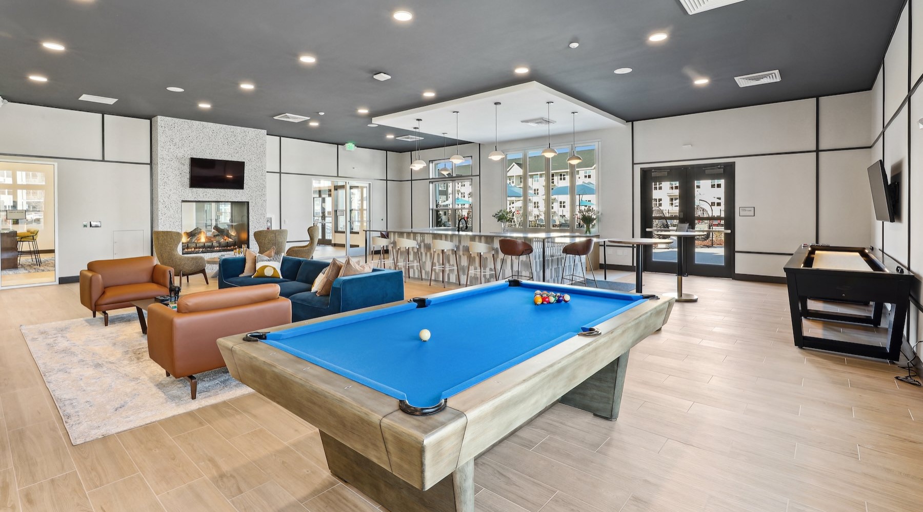 a clubroom with chairs and a pool table
