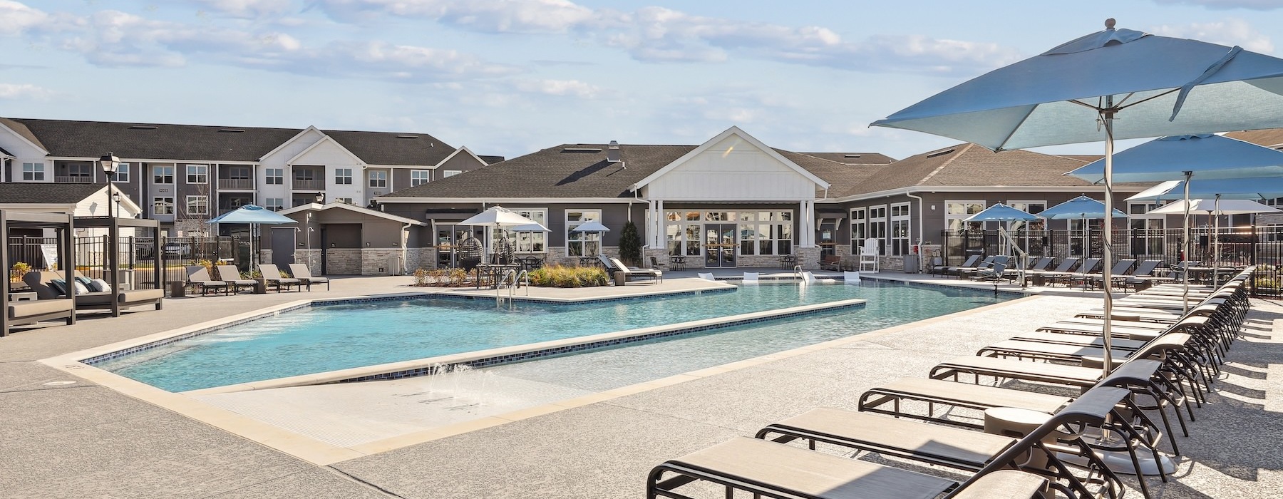 a swimming pool with lounge chairs