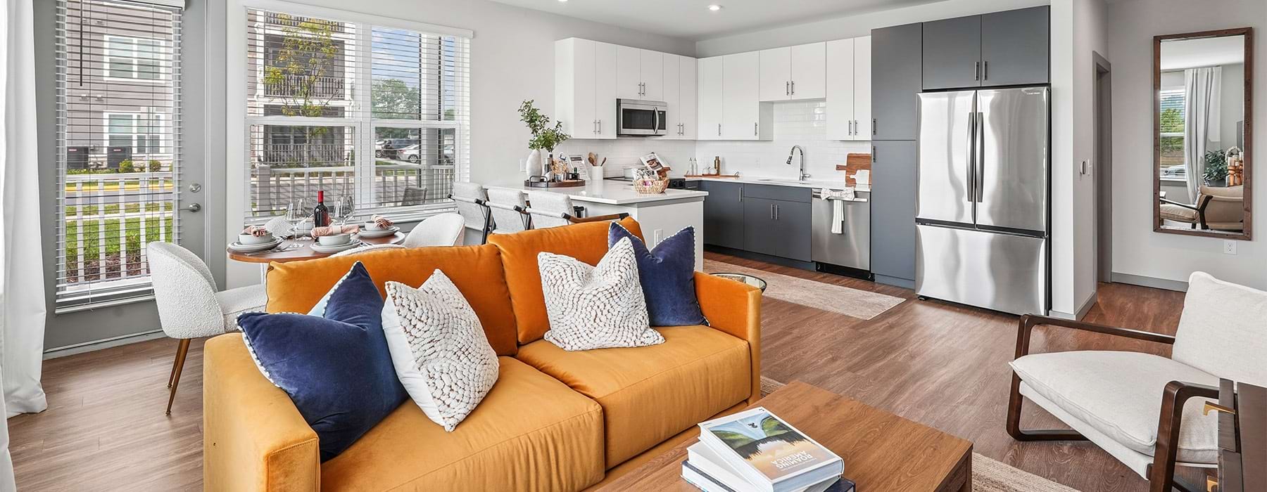 Living room with modern seating and natural light at Alta Cosner Fredericksburg apartment rentals in Virginia.	