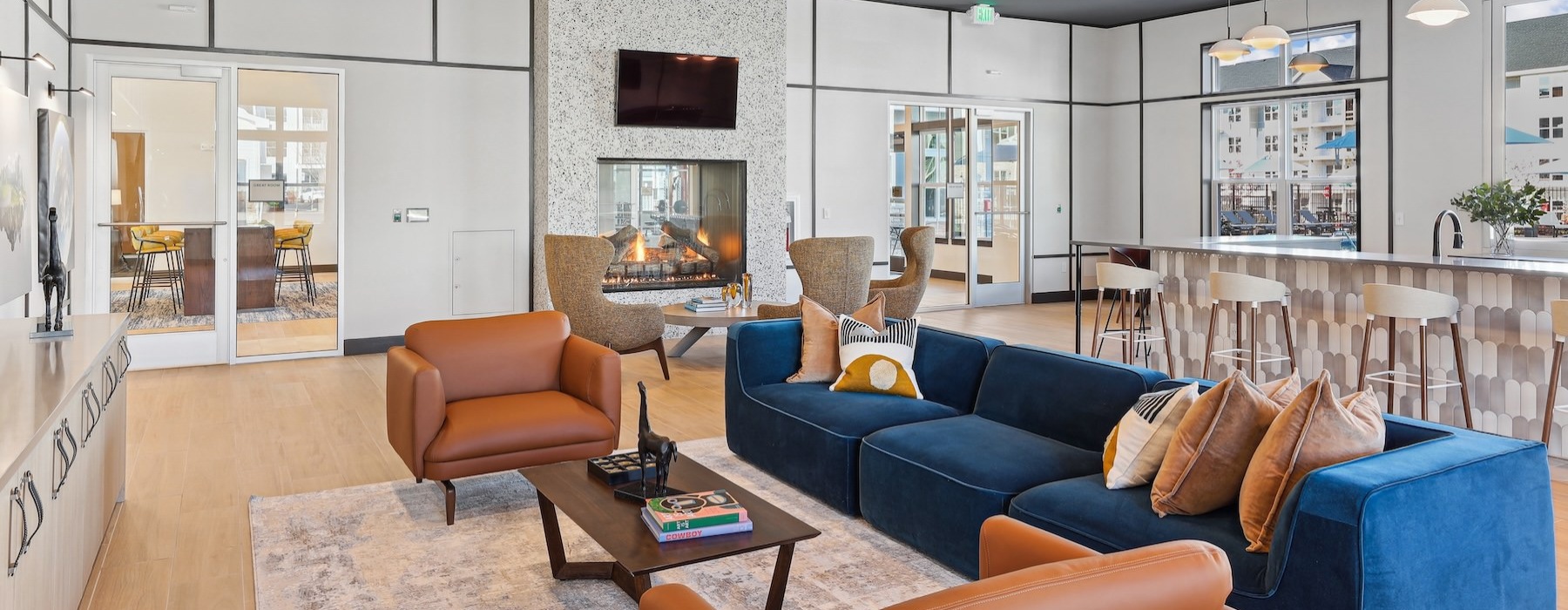a clubroom with a couch, tables and chairs