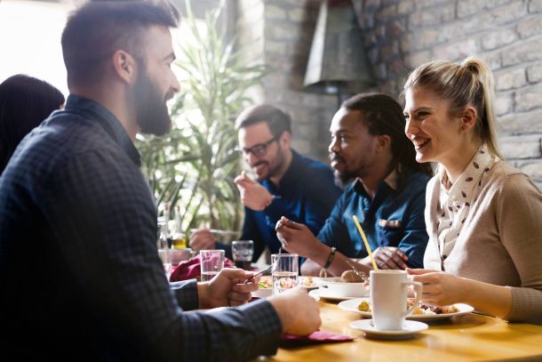 Alta Cosner Luxury Apartments with happy young friends hanging out together in a coffee shop