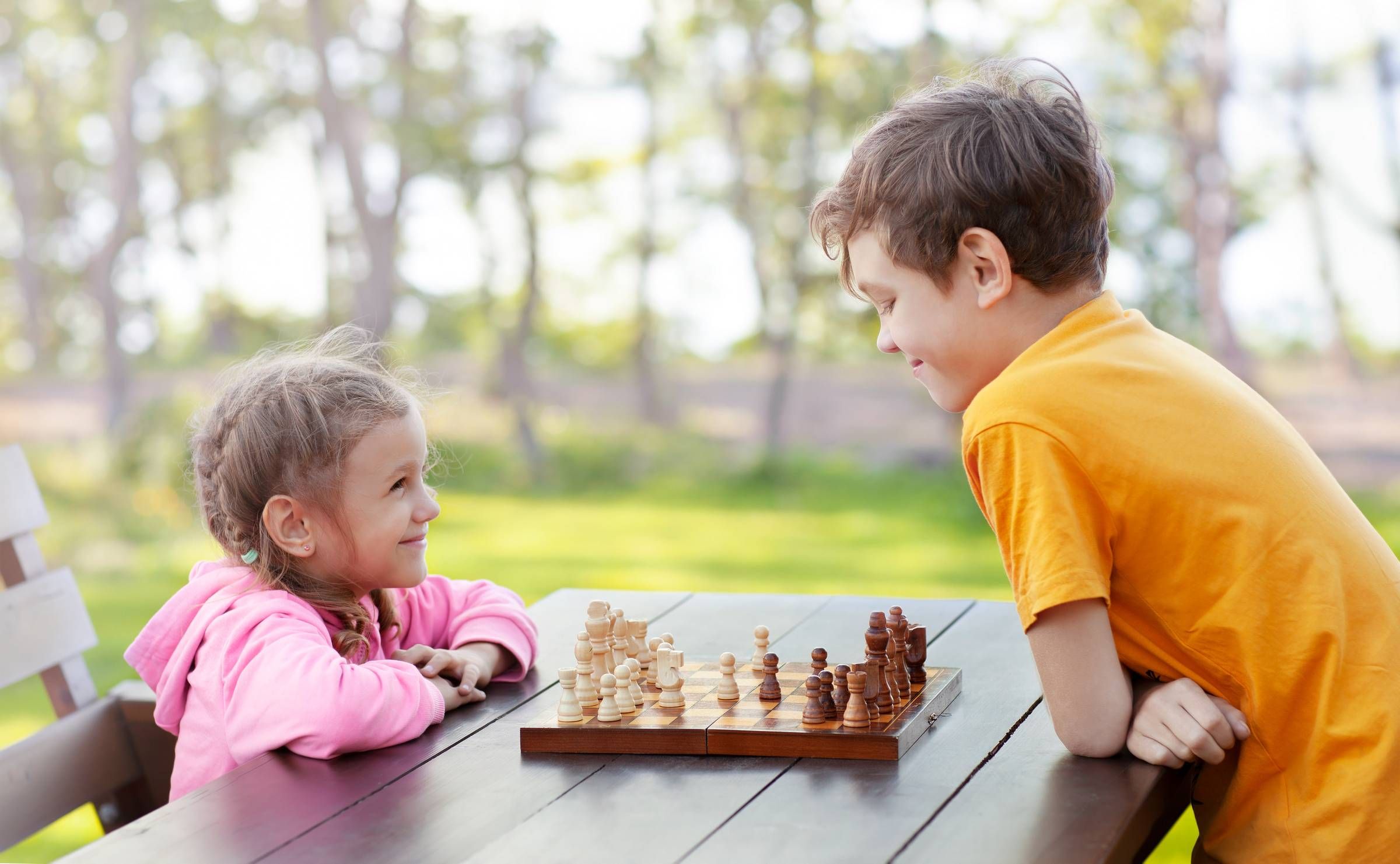 Alta Cosner Luxury Apartments with a brother helping his sister play chess